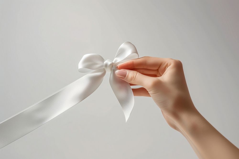 A hand holding ribbon finger.