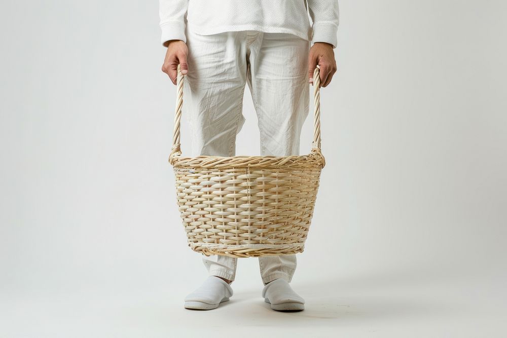 Person holding laundry basket adult white background midsection.
