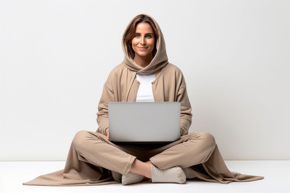 Winner woman sitting on the floor laptop sweatshirt computer.