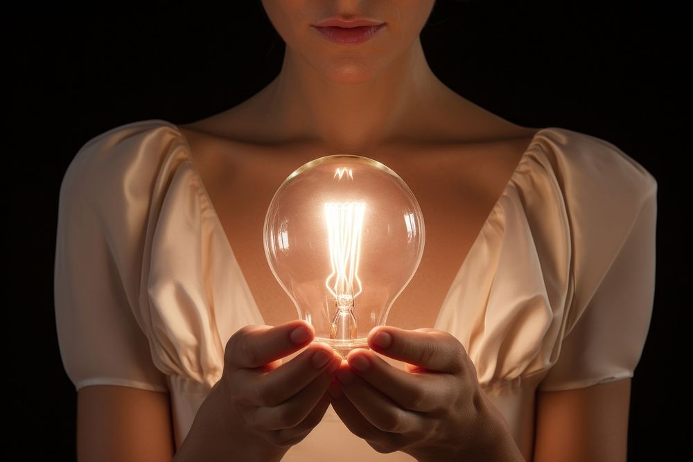 Person holding light bulb lightbulb illuminated electricity.