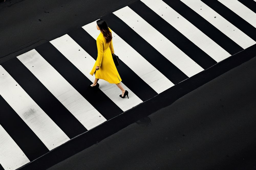 A minimalistic photography of a lady crossing the road advertisment style asphalt adult clapperboard.