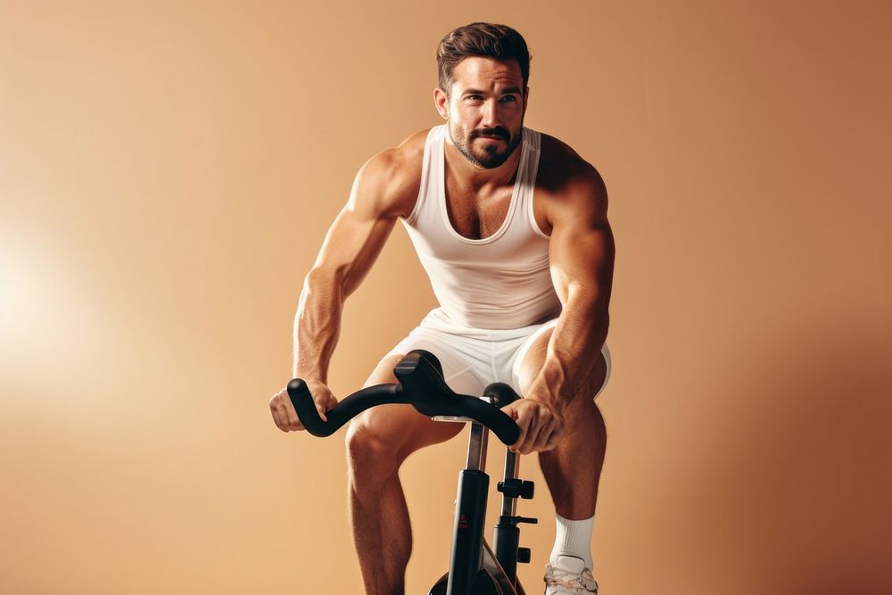 A minimalistic photography of a man exercise cycling at home in advertisment style sports gym determination.