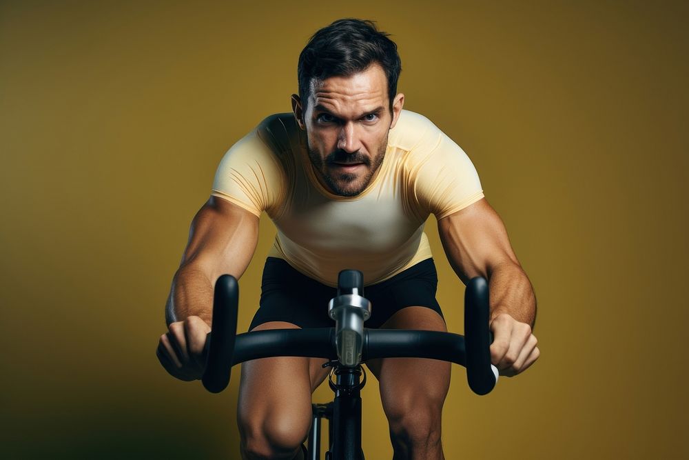 A minimalistic photography of a man exercise cycling at home in advertisment style vehicle sports adult.