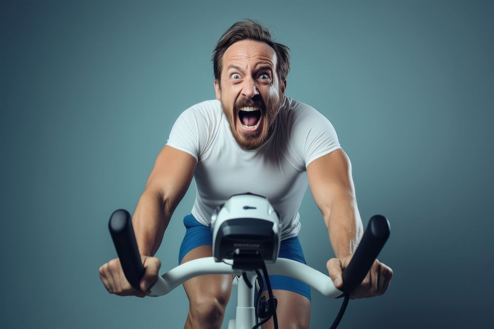 A minimalistic photography of a man exercise cycling at home in advertisment style shouting sports adult.