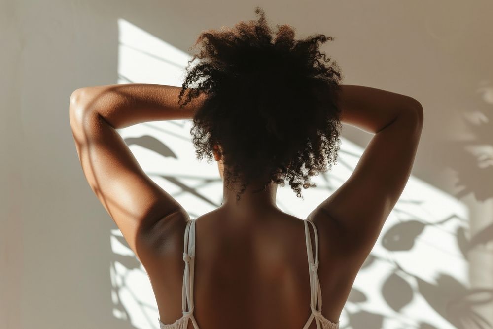 Woman showing her back with skin adult undergarment exercising.
