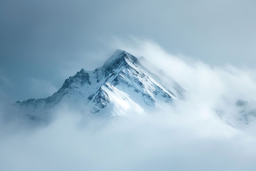 Photo of snowy mountain peek through cloud outdoors nature mountaineering.