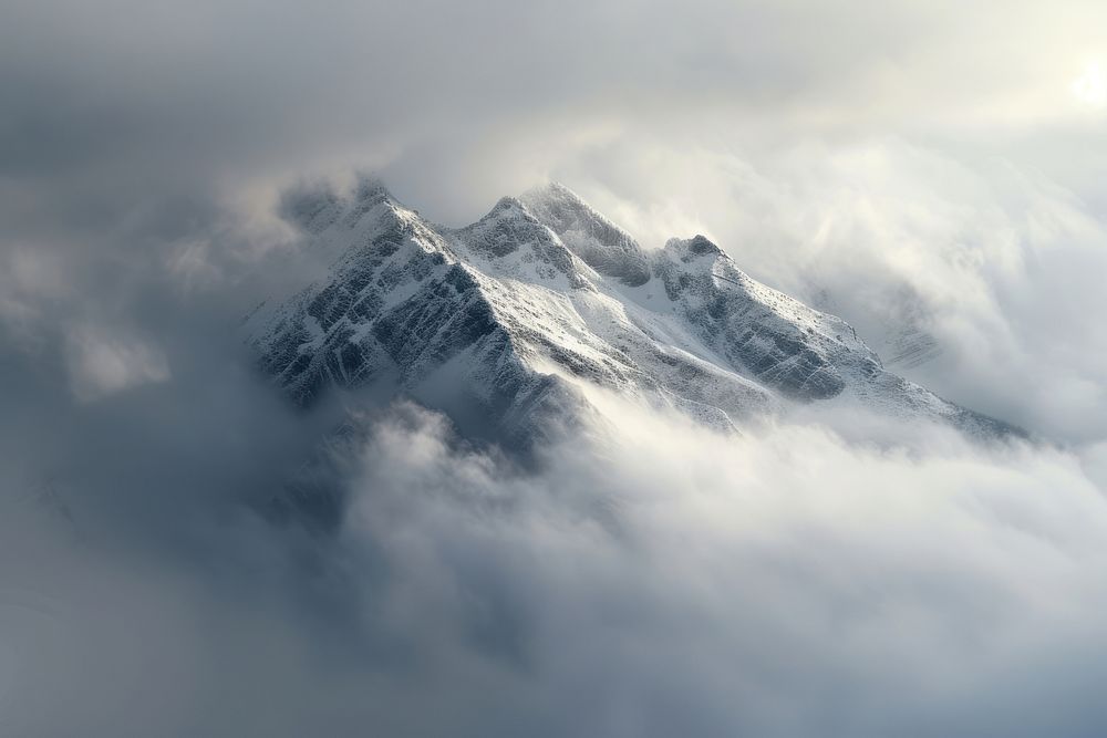 Photo of snowy mountain peek through cloud outdoors nature fog.