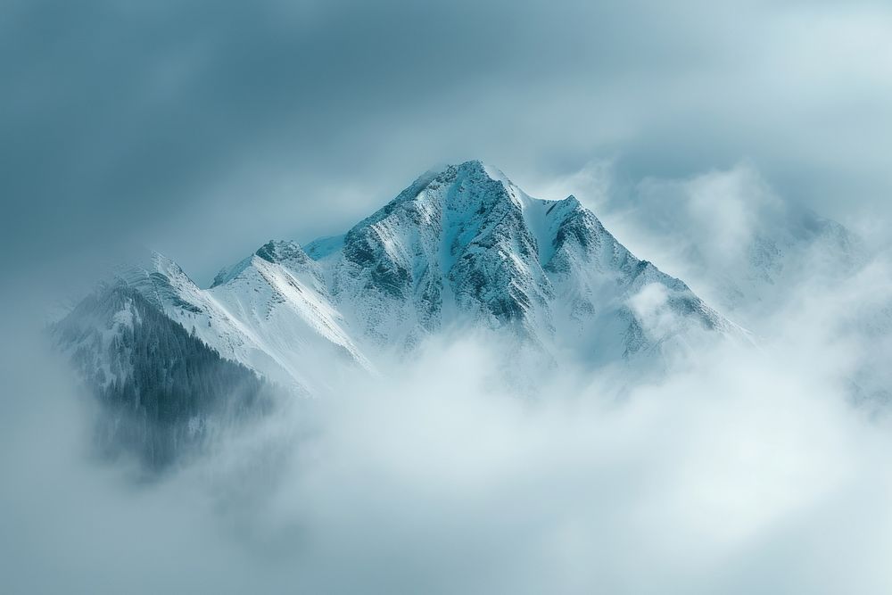 Photo of snowy mountain peek through cloud outdoors nature tranquility.