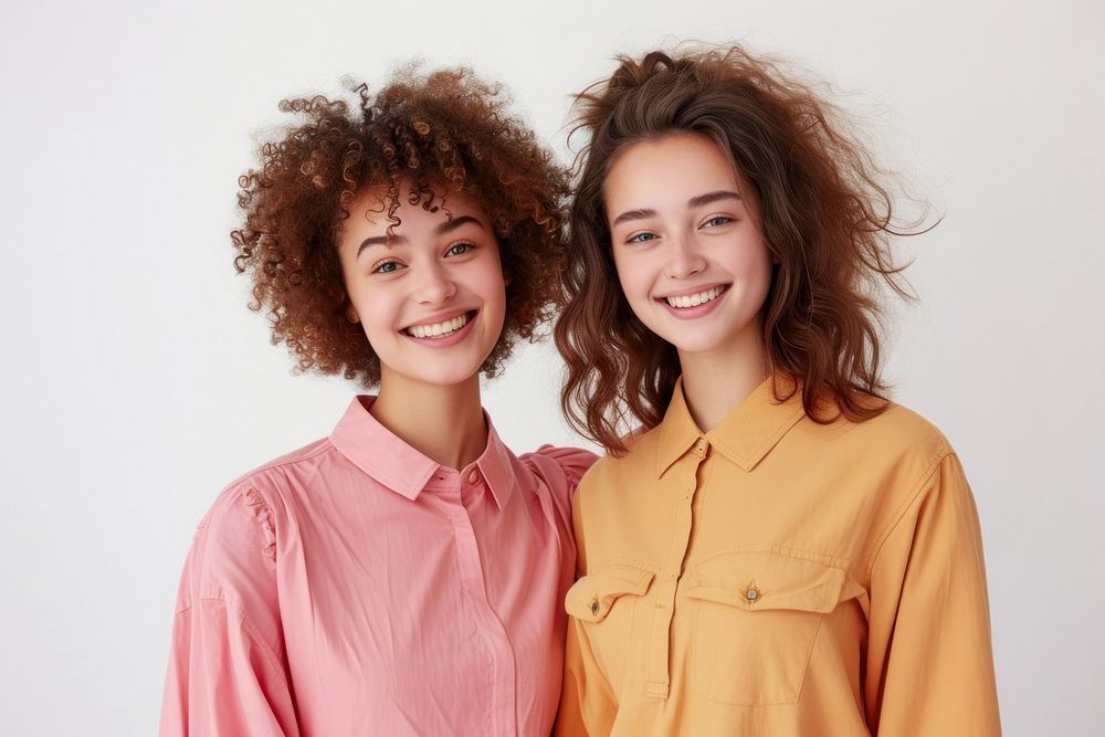 Two friends standing smiling blouse.