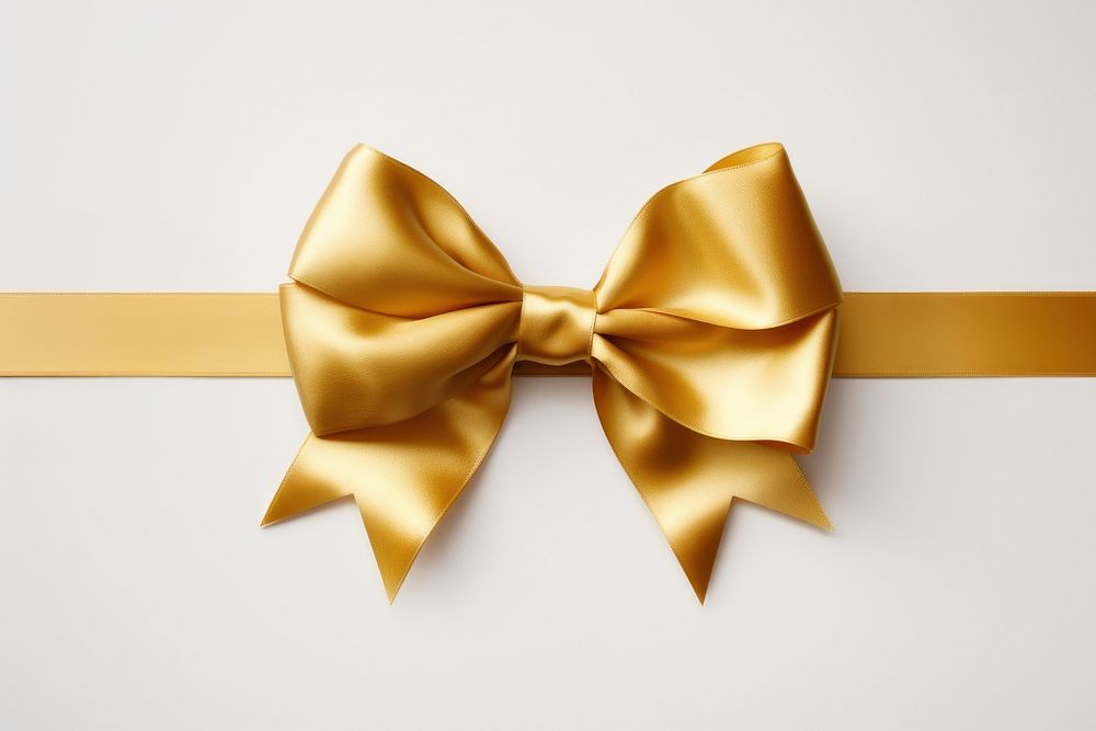 Gold ribbon white background celebration accessories.
