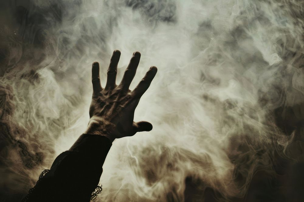 Praying hand smoke silhouette.