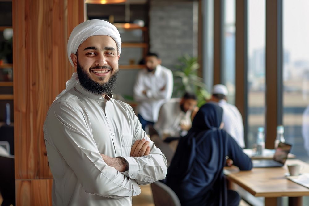 Muslim man stand and smile against business people meeting in meeting room adult table entrepreneur.