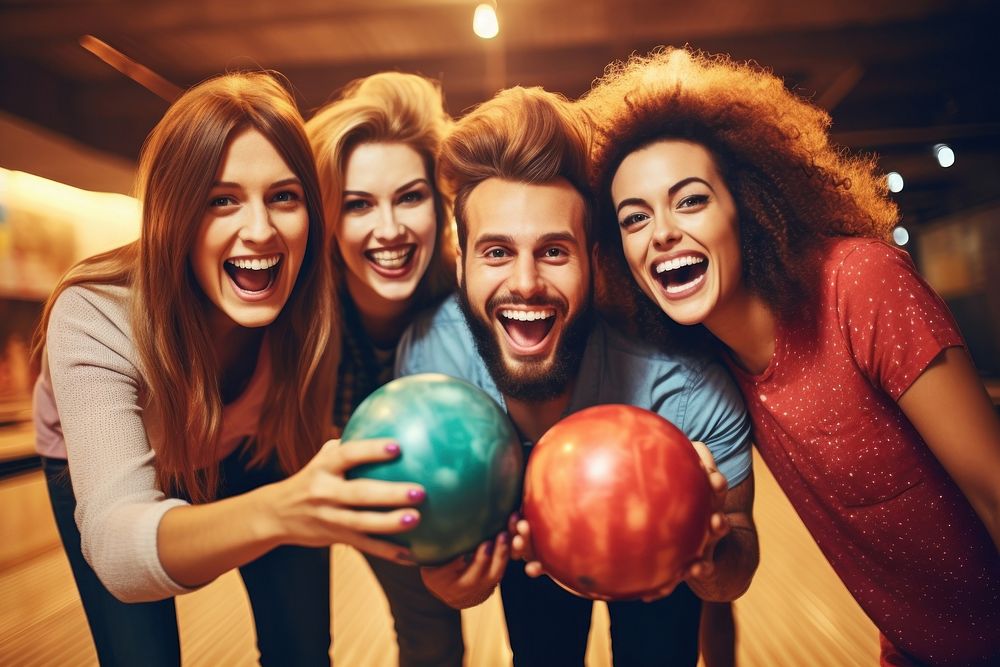 A group of friends playing bowling laughing sports adult.