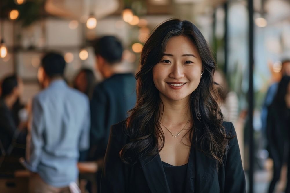 Asian woman stand and smile against business people meeting adult architecture accessories.