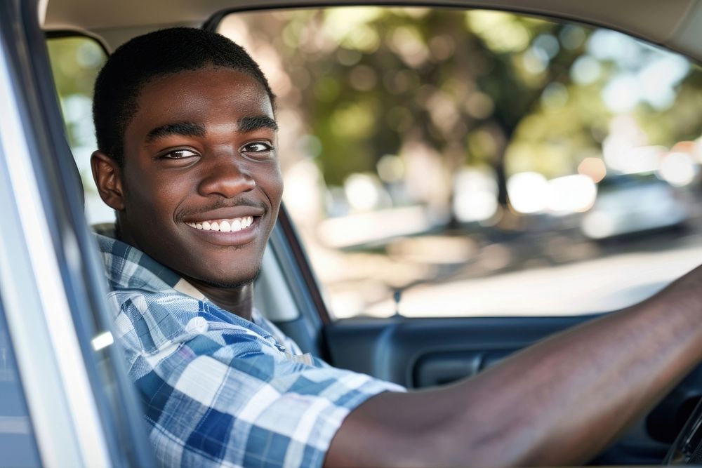 Photo of happy teenager african american man driving car portrait vehicle smile.