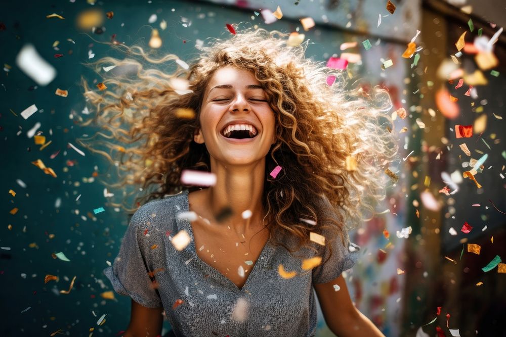 Woman enjoying cheerful laughing confetti illuminated.