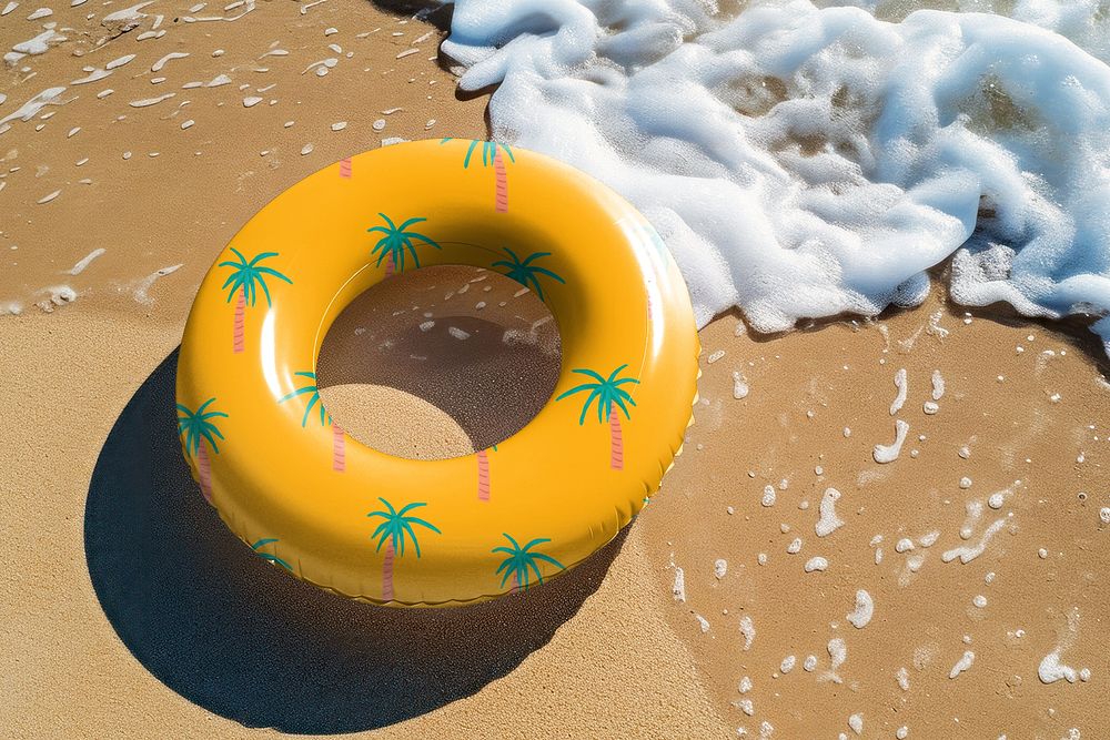Tropical printed swimming ring on beach