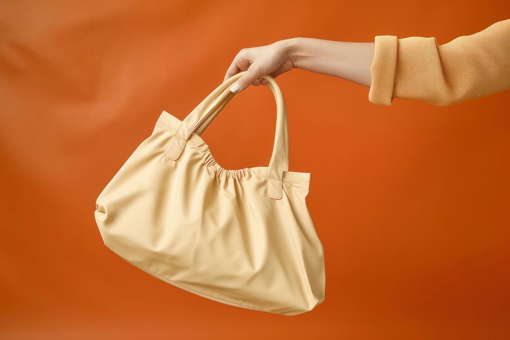 Hand holding bag handbag purse accessories.