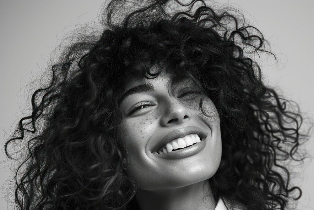 Woman with curly hair smiling portrait laughing smile.