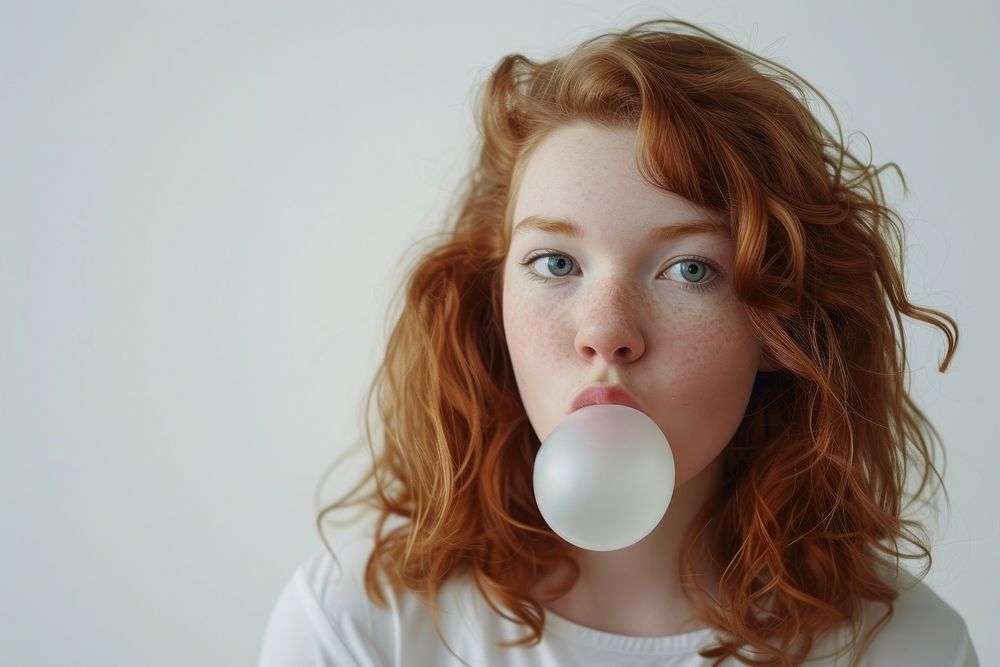 Young woman blows off portrait white gum.