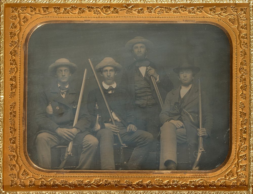 Portrait of four men with rifles