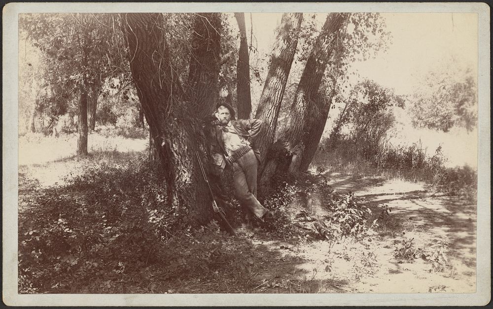 F.A. Williams resting against a tree