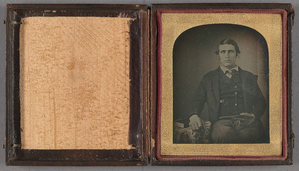 Portrait of a man seated holding a cased daguerreotype