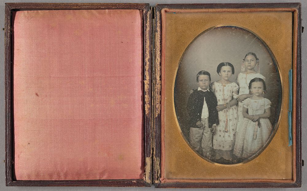 Portrait of three caucasian children and one black child
