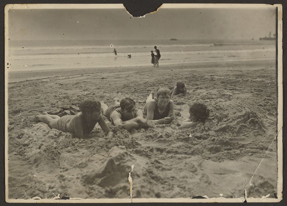 Children Laying in Sand at Beach by Louis Fleckenstein