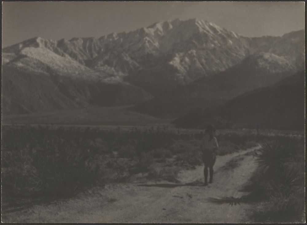 Woman Walking on Path Towards Mountains by Louis Fleckenstein