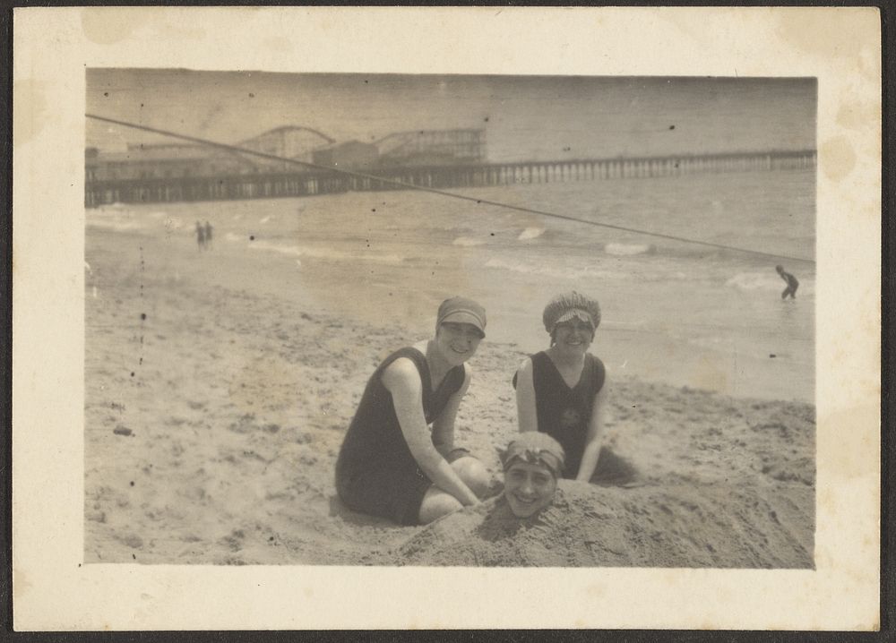 Women on the Beach Burying Friend in Sand by Louis Fleckenstein