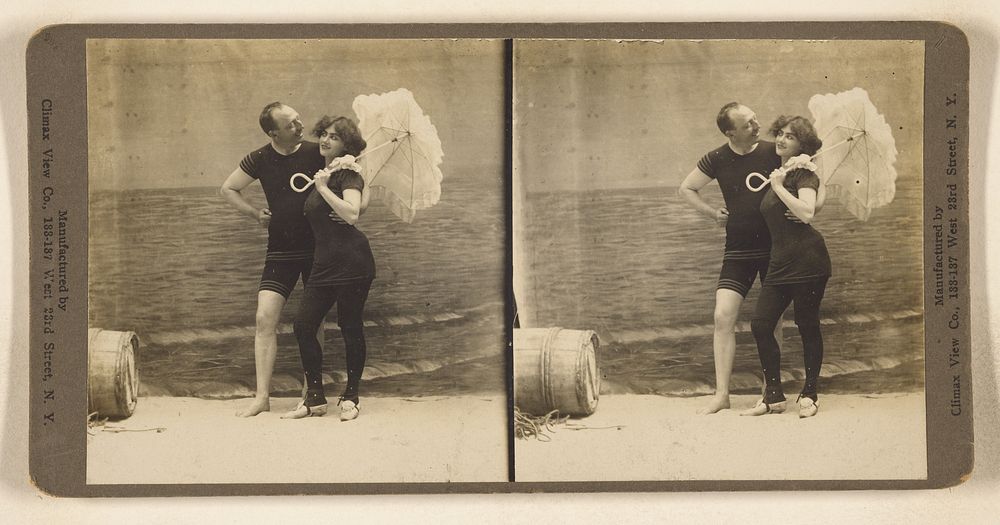 Couple in swimsuits at the beach posing for their picture, woman holding a parasol by Climax View Co