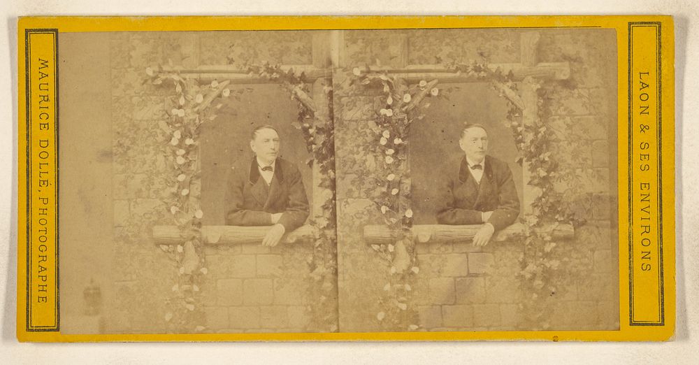 Unidentified man leaning on window sill covered with flowering vine by Maurice Dolle