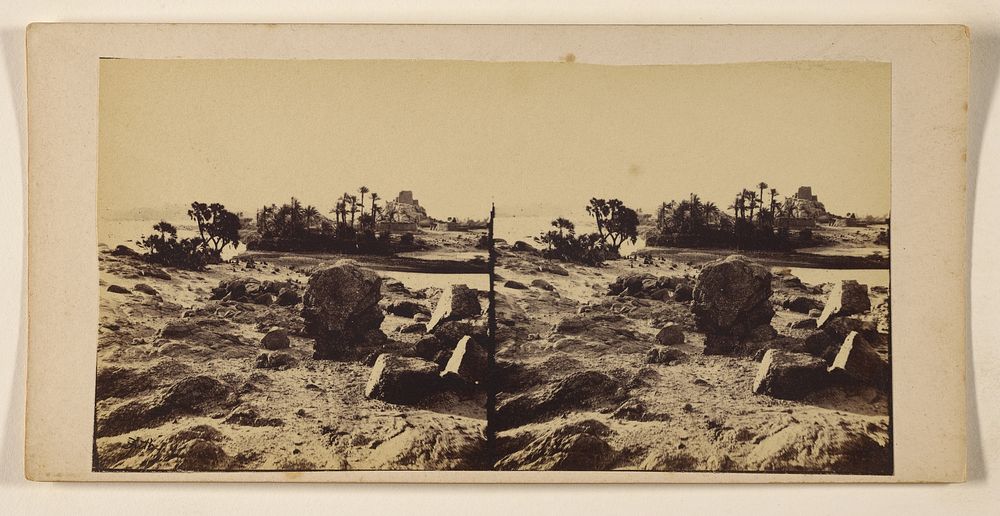 Rocks in foreground, oasis in background by Francis Frith