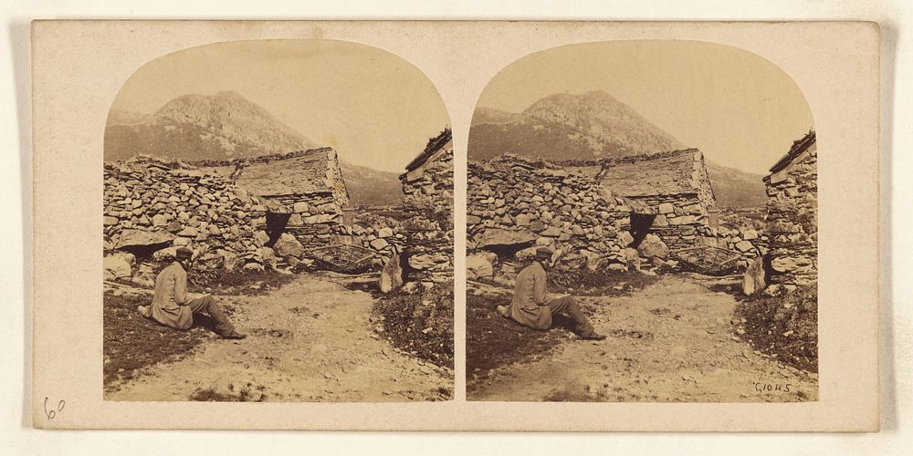 Man seated on road near buildings made of stones by William Grundy