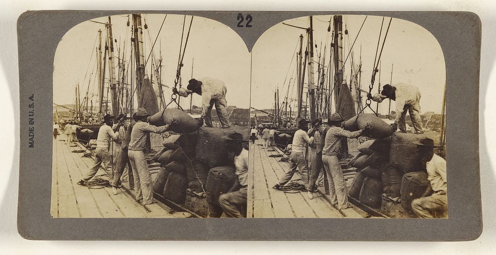Men hauling sacks from ship to dock by Keystone View Co