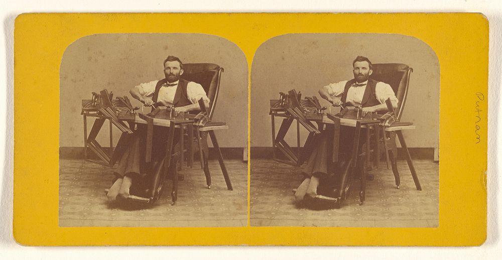 Portrait of Charles H. Barnes, Hardwick, Mass. seated in handicapped-style chair making wooden picture frames by George T…