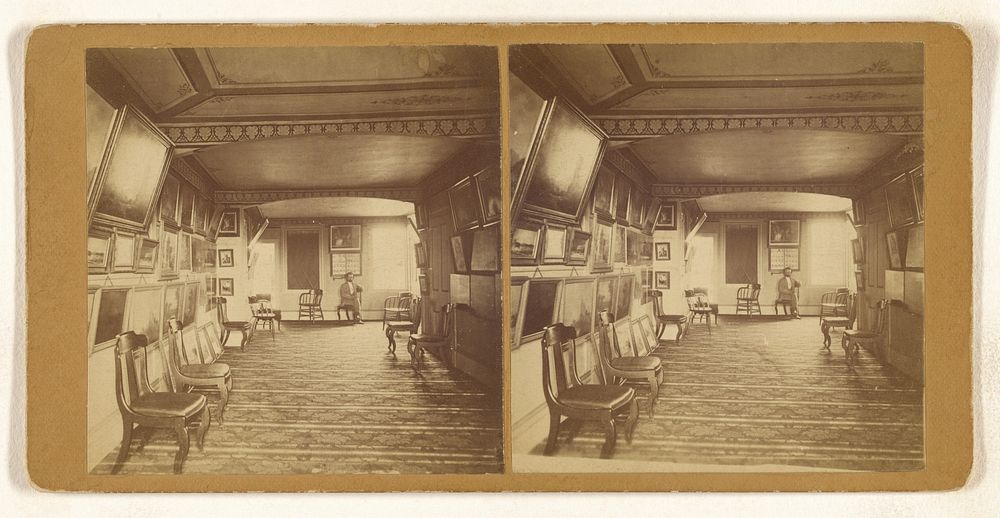 Interior of an art gallery, paintings and photographs on the walls, bearded man seated at back by Horace Partridge and Co