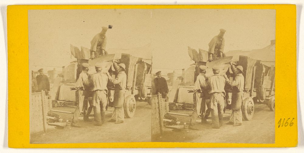 Men loading sheet metal on a truck