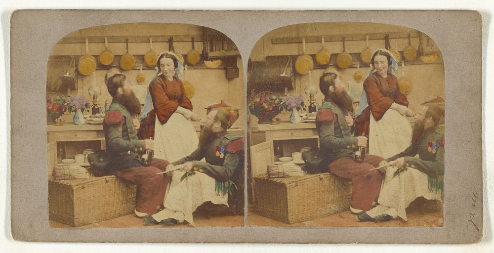 Two bearded men in a kitchen, with a woman who is probably the cook