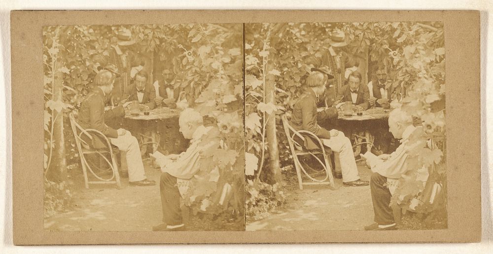 Men playing cards in a garden
