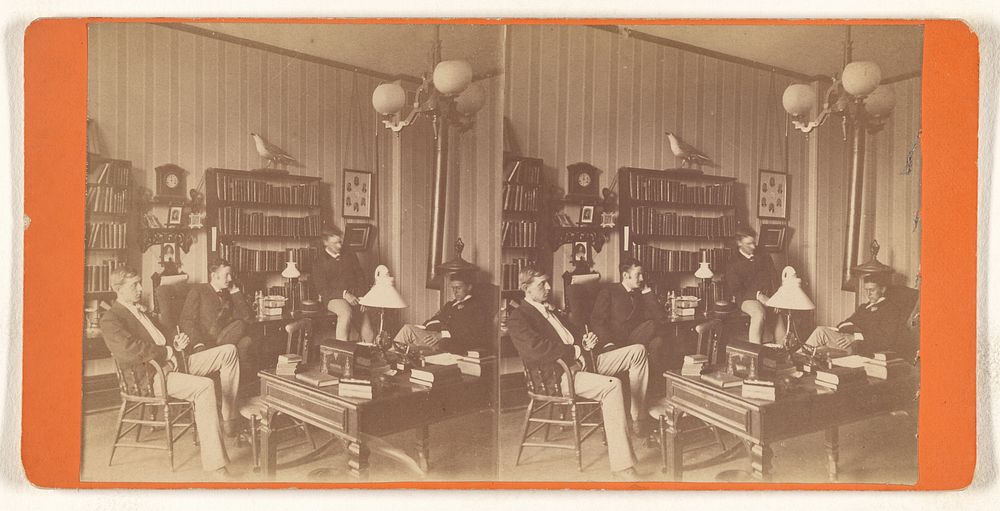 Four men seated in a study or private library