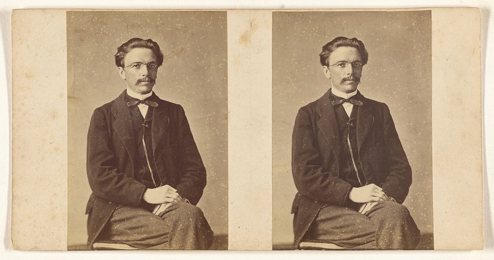 Unidentified man seated, with wire-rimmed glasses & bow tie