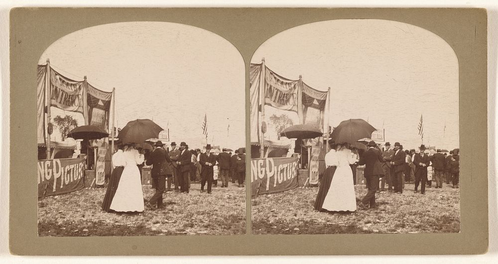 Fairgrounds: people at the venues, some women walking with umbrellas