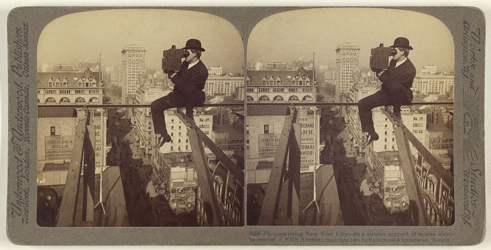 Photographing New York City - on a slender support 18 stories above pavement of Fifth Avenue. by Underwood and Underwood