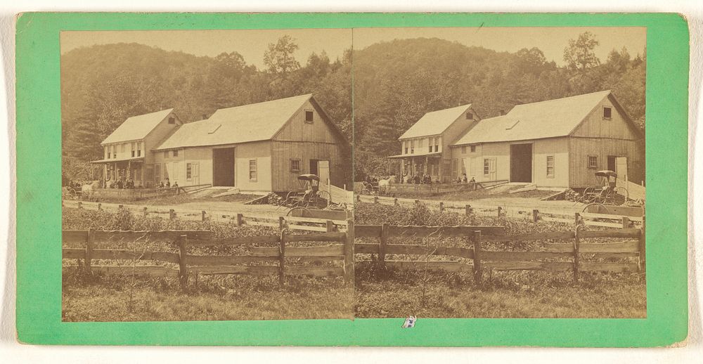 Exterior view of large house and connecting barn, mountain in background, fence in foreground