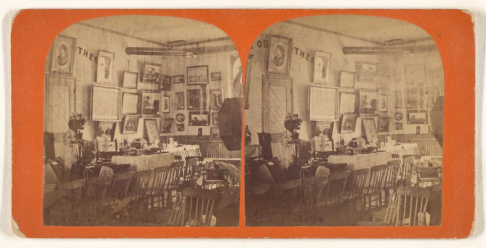 Interior of a room with numerous chairs, paintings on the walls
