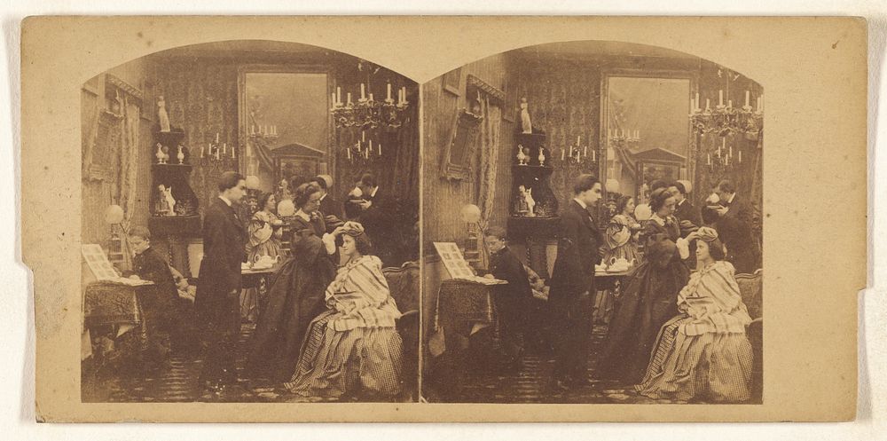 Group of people in a palour, with one woman fixing anothers hair.