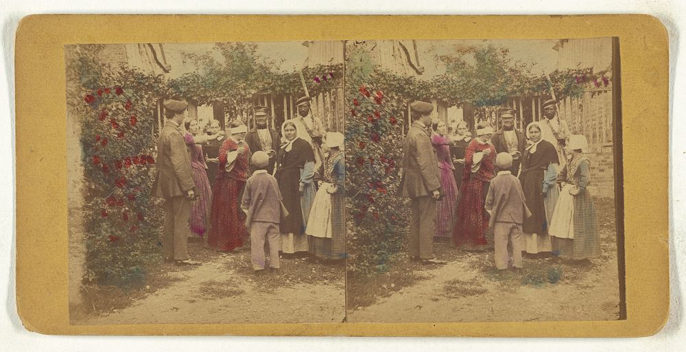 Group of people playing a game in the garden, one woman is blindfolded