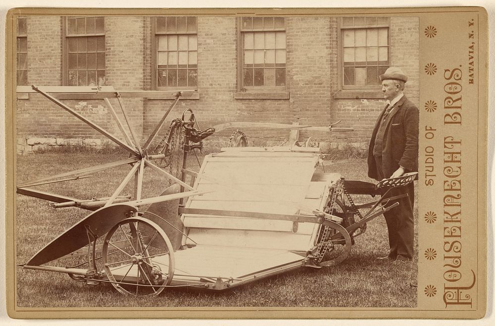Man posing with a piece of farm machinery by Houseknecht and Brothers